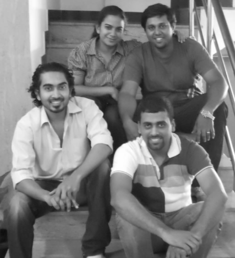 The founding team of The Imagine Trust sitting together on a staircase